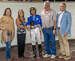 The connections of Rogue Candy accept the Desaix Stakes winning trophy at Delta Downs on Friday.