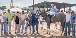 The winning connections of Eg Secret accept the Charlie R’s QH Derby trophy at Great Falls on Sunday.