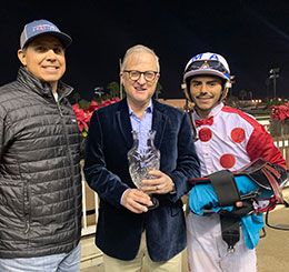 Trainer Juan Aleman, owner Link Newcomb, and jockey Martin Arriaga accept the First Down Dash Stakes trophy at Los Alamitos.