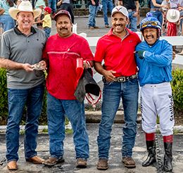 The winning connections of Caliente Operator accept the $50,000 Flying Breed Stakes trophy at Delta Downs on Saturday.