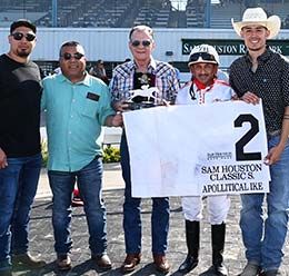 The winning connections of Apollitical Ike accept the Sam Houston Classic Stakes trophy on Saturday.
