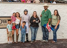The winning connections of Pilot Point Train accept the Louisiana Starter Stakes trophy at Delta Downs on Saturday.