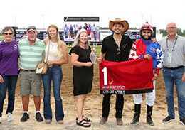 The winning connections of Lets Get After It accept the Jaguar Rocket Futurity stakes trophy at Horseshoe Indianapolis.