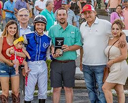 The winning connections of Nbc Mr Booz accept the Louisiana Juvenile Stakes trophy.