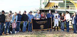 The winning connections of Amarillis accept the Black Gold Fillies Futurity Championship trophy.
