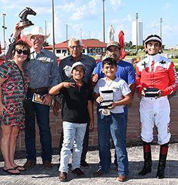 The winning connections of Flashin Dynamite accept the Adequan Prairie Meadows Derby Challenge stakes trophy on Sunday.