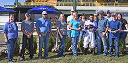 The winning connections of The Criminal accept the $63,767 John Deere Juvenile Challenge [G3] trophy at Will Rogers Downs on Sunday.