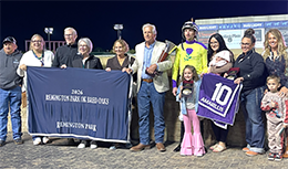 The winning connections of Amarillis accept the Remington Park Oklahoma-Bred Oaks stakes trophy Saturday night.