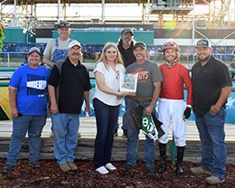 The winning connections of R Cowgirl accept the Ray Graves Memorial trophy at Fair Meadows on Saturday.