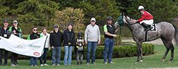The winning connections of The Batmann accept the Ontario Sired Stakes Derby trophy at Ajax Donwn on Monday.