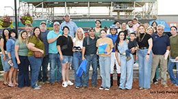 The winning connections of Cuz Eyema Cowboy Baby accept the Masterpiece Derby stakes trophy at Fair Meadows.