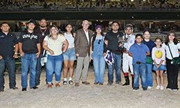 The winning connections of As Moonflash accept the Selma Stakes trophy at Retama Park Thursday night.
