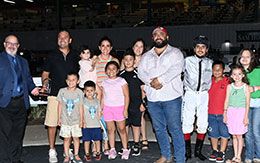 The winning connections of Seis Chilitos accept the Sam Houston Juvenile Stakes trophy.