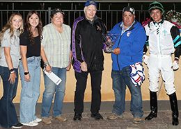 The winning connections of Relentless Flash accept the $22,000 Cash Caravan Stakes trophy at Canterbury Park on Thursday.