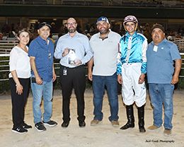 The winning connections of Embers Time accept the $58,625 TQHA 250 Stakes winning trophy on Friday at Retama Park.