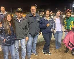 The winning connections Paul and Marin Jones, assistant Roque Gonzalez, and jockey Jesus Rios Ayala and family, accept the Kaweah Bar Handicap stakes trophy.