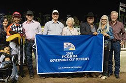 The winning connections of Mayor Humdinger accept the Governor's Cup Futurity stakes trophy on Saturday.
