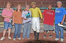 The winning connections of Mondays Cartel accept the $16,850 Fair Meadows Juvenile Stakes trophy at Fair Meadows in Tulsa on Saturday.