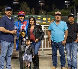 Trainer Juan Aleman (left) accepting the Sound Dash trophy with Mr. and Mrs. Arriga and friends at Los Alamitos Race Course.