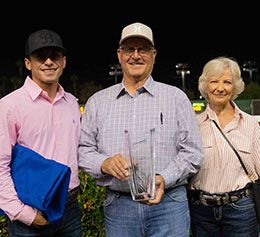 In the winner's circle, assistant Heraclio Botello, owner-breeder and trainer Mike Casselman, and his wife Sharon.