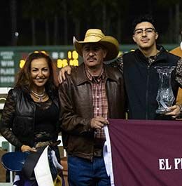 Trainer Eleana Andrade and owners Mario and Oscar Montel accept the El Primero Del Ano Derby stakes trophy.