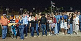 The winning connections of Astronomical 123 accept the Independence Day Stakes trophy.