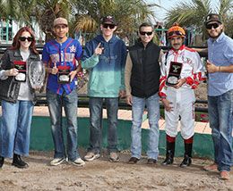 The winning connections of Tina Katrina accept the Mike Hastings Memorial Stakes trophy at Turf Paradise.