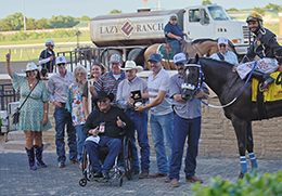 The winning connections of Pyc Dollars Cowboy accept the Easy Jet Stakes trophy on Saturday at Remington Park.