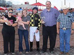 The winning connections of Nothin Like You accept the $40,000 Keokuk Stakes trophy at Prairie Meadows on Sunday.