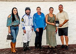 The winning connections of Dropping Dimes accept the Louisiana Classic Stakes trophy at Delta Downs on Saturday.