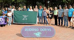 The winning connections of Alamos accept the Ruidoso Mountain Top QH New Mexico Bred Derby stakes trophy on Saturday at Ruidoso Downs Racetrack & Casino.