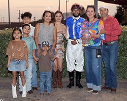 The winning connections of Mr High Five accept the Rainbow Invitational trophy at Albuquerque Downs on Saturday.