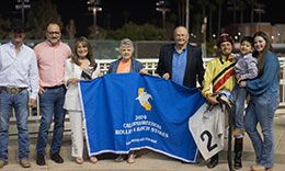 Cathy Allred, James Glenn, and Jesus Rios Ayala in the winner's circle with Dino Perez presenting the Rolling A Ranch Matron Stakes trophy.