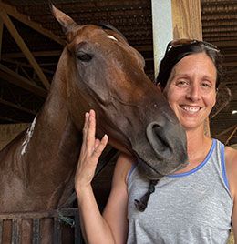 Natasha Perez with one of her horses, Porkyismyname, in her barn at Horseshoe Indianapolis.