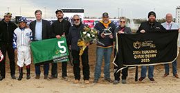The winning connections of Runninagainstdwind accept the Governors' Juvenile stakes trophy at Horseshoe Indianapolis.