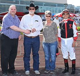 The winning connections of Lipstick Lou accept the $99,375 Prairie Meadows Gold Derby trophy at Prairie Meadows on Sunday.