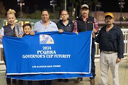 Enrique Gonzalez and the winning connections of Favorite Jesshawk accept the Governors' Cup Futurity stakes trophy.