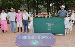 The winning connections of Real Runaway Rime accept the Ruidoso Maiden Stakes trophy on Saturday at Ruidoso Downs Racetrack & Casino.