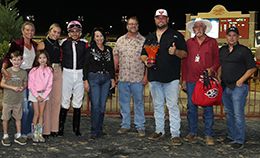 The winning connections of Wl You Aint No Cowboy accept the $35,000 Karen Utecht Memorial Stakes trophy at Lone Star Park on Saturday.