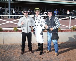 The winning connections of Handin Out Candy accept the $100,000 King Rick Rack Stakes-G2 trophy at Zia Park on Sunday.