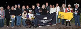 Mark Herron presents the winning trophy to Streak Of Powers owners Ken and Nina O'Brien.
