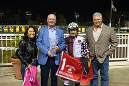 The winning connections of Beuteeful accept the $415,500 Los Alamitos Oaks trophy at Los Alamitos on Saturday.