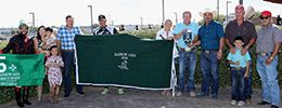 The winning connections of Running To the Moon accept the $482,000 Rainbow Oaks [G1] trophy at the Downs at Albuquerque on Sunday.