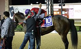 Trainer Jed Vane and jockey Juan Pulido embrace after winning the richest race in Texas Saturday at Lone Star Park.