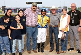 The winning connections of Famous Lollipop accept the Carter Riley Overnight Stakes trophy at Horseshoe Indianapolis.