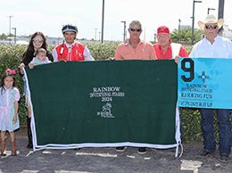 The winning connections of Rj Having Fun accept the Rainbow QH Invitational Stakes trophy.