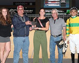 The winning connections of Kiss My White Socks accept the North Star Futurity stakes trophy at Canterbury Park.