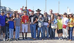 The winning connections of Ab Boogie accept the Polk County Derby stakes trophy.