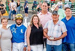 The winning connections of One Fast Cajun accept the Virgil Bond Stakes trophy.