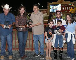 The winning connections of Curls Joyful Wagon accept the $39,644 Cox Ranch Lone Star Distaff Challenge trophy at Lone Star Park on Saturday.